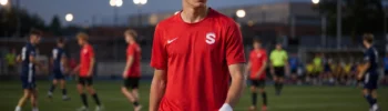 Young football player focused before a night match or football trial on the pitch.